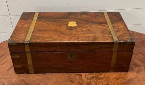 A rosewood and brass banded writing box with fitted interior