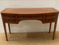 A yew sideboard, bow fronted four drawer configuration (H79cm W130cm D51cm)
