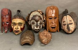 A selection of wall hanging tribal masks