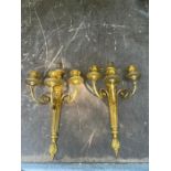 A pair of gilt three arm wall sconces