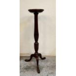 A mahogany plant stand with carved central column on splayed legs (H109cm)