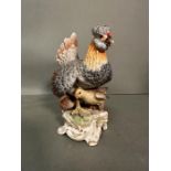 A Meissen figure of hen with chicks. H 16.5cm