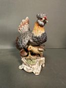 A Meissen figure of hen with chicks. H 16.5cm