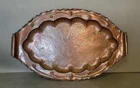 A good Newlyn school hand embossed and planished oval fish dish, with crimped rim, scroll handles,