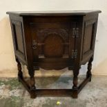 An oak three panel side cabinet with central carved panel (H71cm W81cm D33cm)