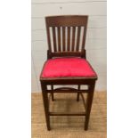 A high barstool with red upholstery