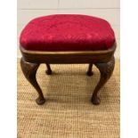 A George II style stool with cabriole legs and upholstered seat