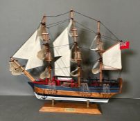 A wooden scale model of HMS Endeavour on plinth