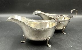 A pair of silver sauce boats on three feet, approximate total weight 187g, hallmarked by George