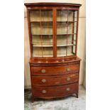 A bow fronted secretaire style bookcase with three graduating drawers (H190cm W103cm D49cm)