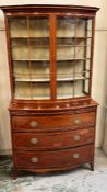 A bow fronted secretaire style bookcase with three graduating drawers (H190cm W103cm D49cm)