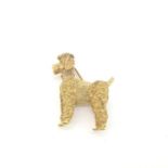 A yellow gold poodle brooch with ruby eyes. Marked 18 carat gold