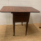 A four drawer mahogany Pembroke table comprising of four drawers on reeded legs (H71cm W89cm D57cm)