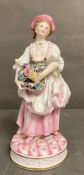 An 19th Century Bisque figure of a lady holding flowers