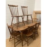 A Mid Century dining room table and six spindle back chairs (152cm x 83cm)