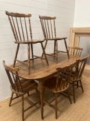 A Mid Century dining room table and six spindle back chairs (152cm x 83cm)