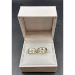 A pair of his and hers engraved wedding rings in silver and 9ct gold (Approximate Total Weight 12.