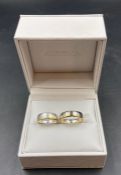 A pair of his and hers engraved wedding rings in silver and 9ct gold (Approximate Total Weight 12.