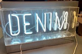 A neon "Denim" sign