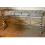 A wooden console table with barley twist and drawer to centre with a distress painted patina (