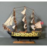 A wooden scale model of HMS Victory on plinth