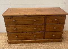 A six drawer pine chest of drawers (H67cm W118cm D44cm)
