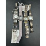 A selection of four watches, several by Israeli artist Ravid.