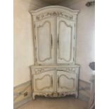 A large French style corner unit with panelled doubled doors to top and bottom opening to reveal