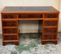 A reproduction pedestal desk with blue leather top (H78cm W122cm D60cm)