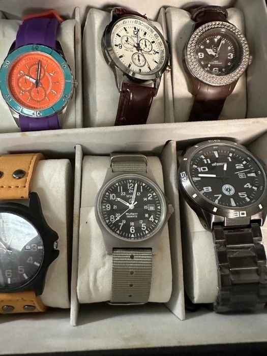 A selection of wristwatches in display case to include: Bulova, Geneva, Skmei, Infantry, 18 in - Image 2 of 6