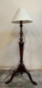 A carved mahogany floor standing lamp on splayed feet (H103cm)