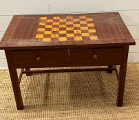 A games table with a checker board top with two drawers to centre and chess pieces in drawer (