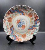 A single 19th Century Chinese Imari plate with scalloped edge and central Foo Dog decoration.