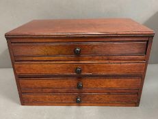 A four drawer mahogany collectors chest