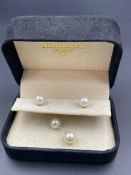 A pair of pearl earrings