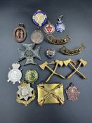 A selection of military insignia and rifle club badges.