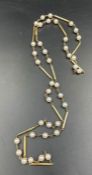 A hallmarked 9ct yellow gold pearl and gold necklace. Made from thirteen solid round wire bars