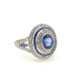 Platinum oval sapphire and diamond target ring with split sapphire and diamond shoulders. Ring is