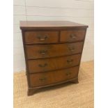 A mahogany bow fronted two over three chest of drawers with brass drop handles (H91cm W78cm D55cm)