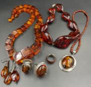 A large selection of quality Baltic amber jewellery to include three necklaces and three silver