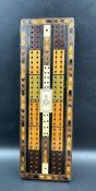 A very interesting Victorian cribbage board made of Various woods with the Masonic set Square and