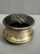 A Sterling silver and tortoiseshell powder box with scrolled motif on lid. Hallmarked London