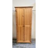 A pine wardrobe with single hanging rail and shelf over (H176cm W78cm D52cm)