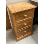 A pine three drawer side cabinet or bedside (H67cm W38cm D32cm)