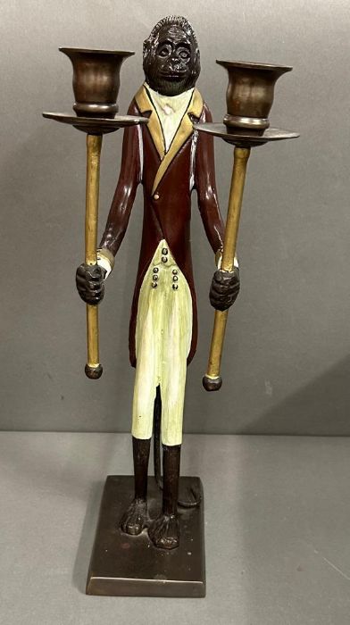 A two arm candlestick in the form of a monkey in a Butlers suit.