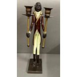 A two arm candlestick in the form of a monkey in a Butlers suit.