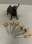 A cast metal Toledo bull with six cocktail sticks