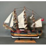 A wooden scale model of HMS Endeavour on plinth