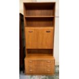 A Mid Century G Plan three drawer sideboard with drop down drinks cabinet and two shelves above (