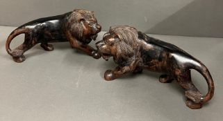 A pair of carved wooden lions